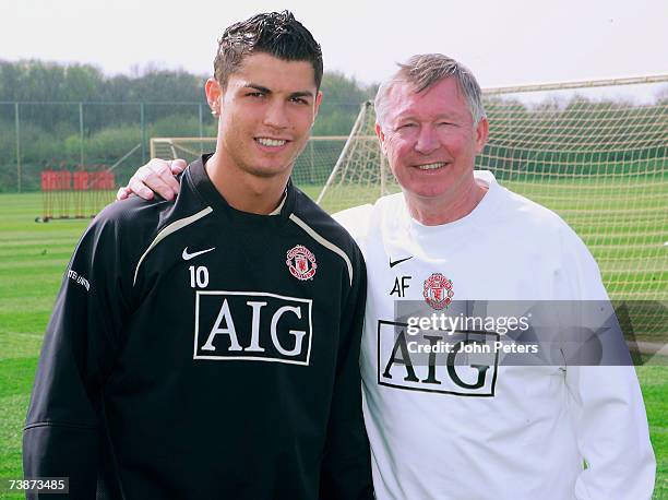 Cristiano Ronaldo of Manchester United poses with Sir Alex Ferguson after agreeing a new five-year deal at the club during a first team training...