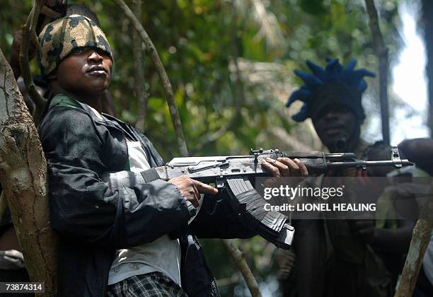 An Ateke Tom militant stands guard at his camp, 13 April 2007, in Okrika, Rivers State. Many militant groups in the delta say they are fighting for...