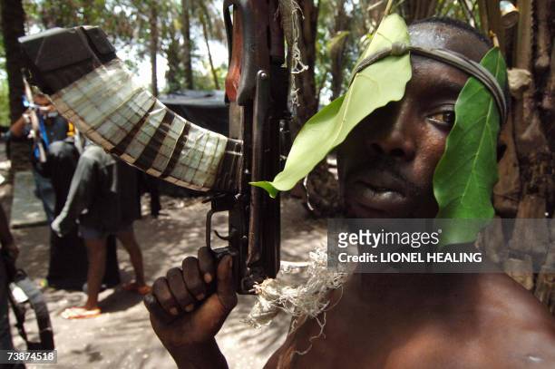 An Ateke Tom militants stands with his guns in his camp, 13 April 2007, in Okrika, Rivers State. Ateke Tom is the leader of the Niger Delta...