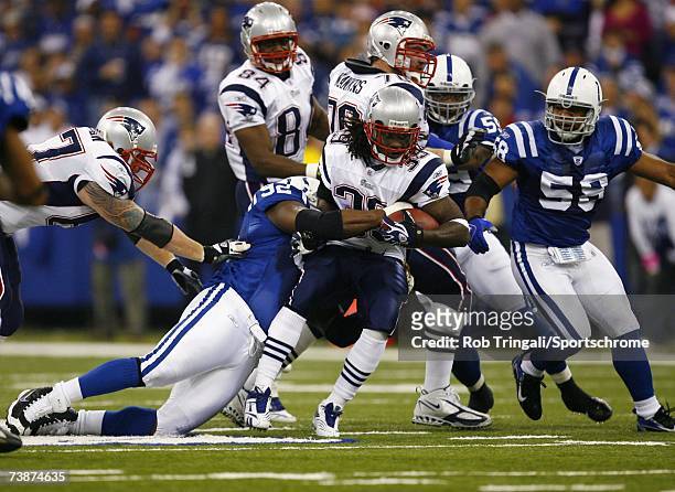 Running back Laurence Maroney of the New England Patriots rushes the ball as Anthony McFarland of the Indianapolis Colts makes the tackle during the...
