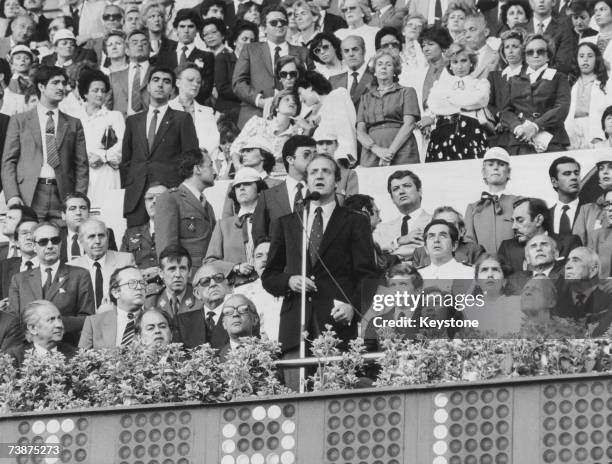 King Juan Carlos I of Spain delivers the opening speech of the World Cup at the Nou Camp stadium in Barcelona, 13th June 1982. From left to right,...