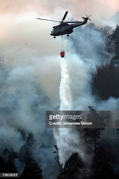 Police helicopter releases water to fight a mountain forest fire on April 13 near Bad Reichenhall, Germany. "Peggy", a high pressure system with...