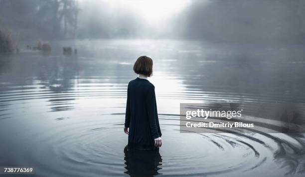 woman wading in rippling river - waden stockfoto's en -beelden