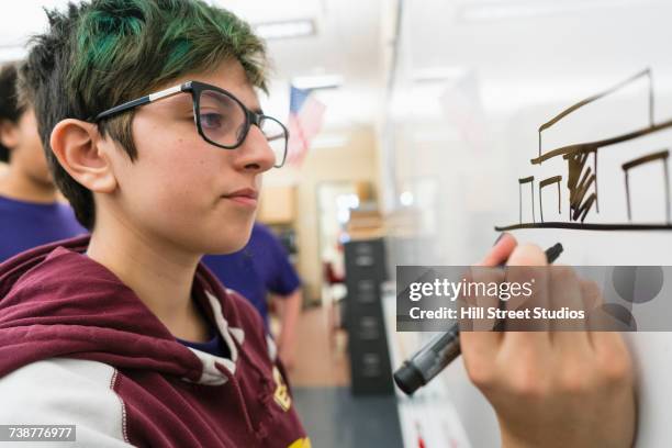 native american girl drawing diagram on whiteboard in school - robot pen stock pictures, royalty-free photos & images
