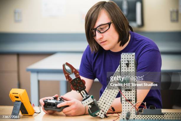boy using controller with robotics at school - pre game stockfoto's en -beelden