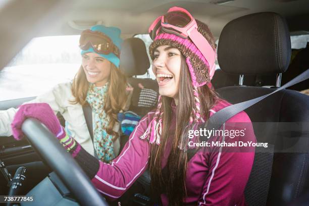 women driving in car in winter and laughing - sports car photos et images de collection