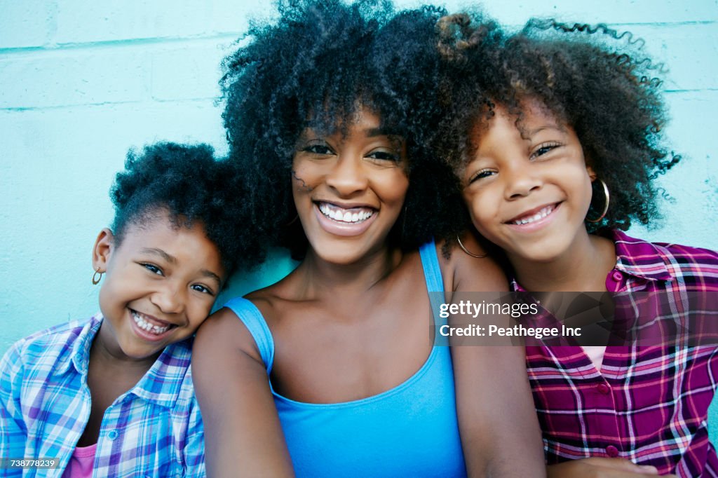 Portrait of smiling mother and daughters