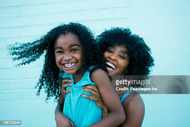 portrait of black mother and daughter laughing - funny black girl stock pictures, royalty-free photos & images