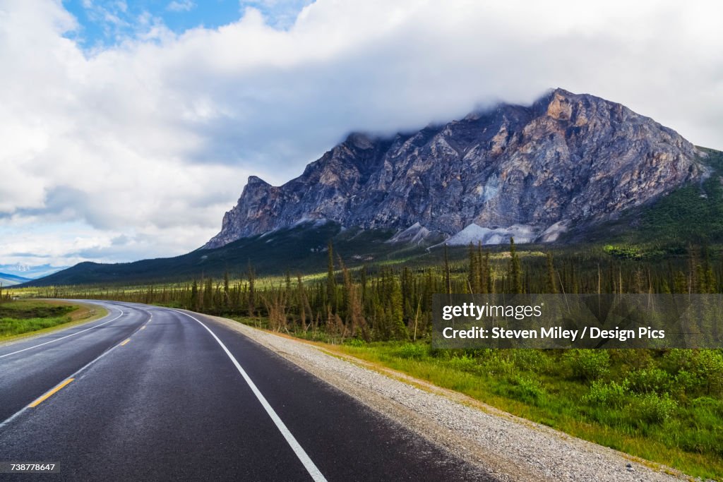 Morning clouds cover the top of Sukakpak Mountain beside the Dalton Highway, North of Wiseman above the Arctic Circle
