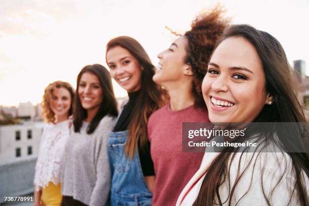 portrait of smiling women on urban rooftop - portrait close up woman 20 29 stock pictures, royalty-free photos & images