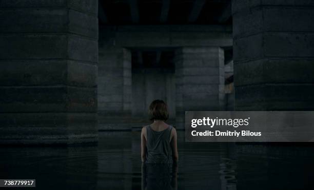 caucasian woman standing waist deep in water - waist deep in water stock pictures, royalty-free photos & images