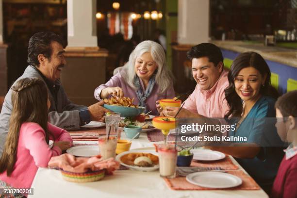 family enjoying dinner in restaurant - family restaurant stock-fotos und bilder