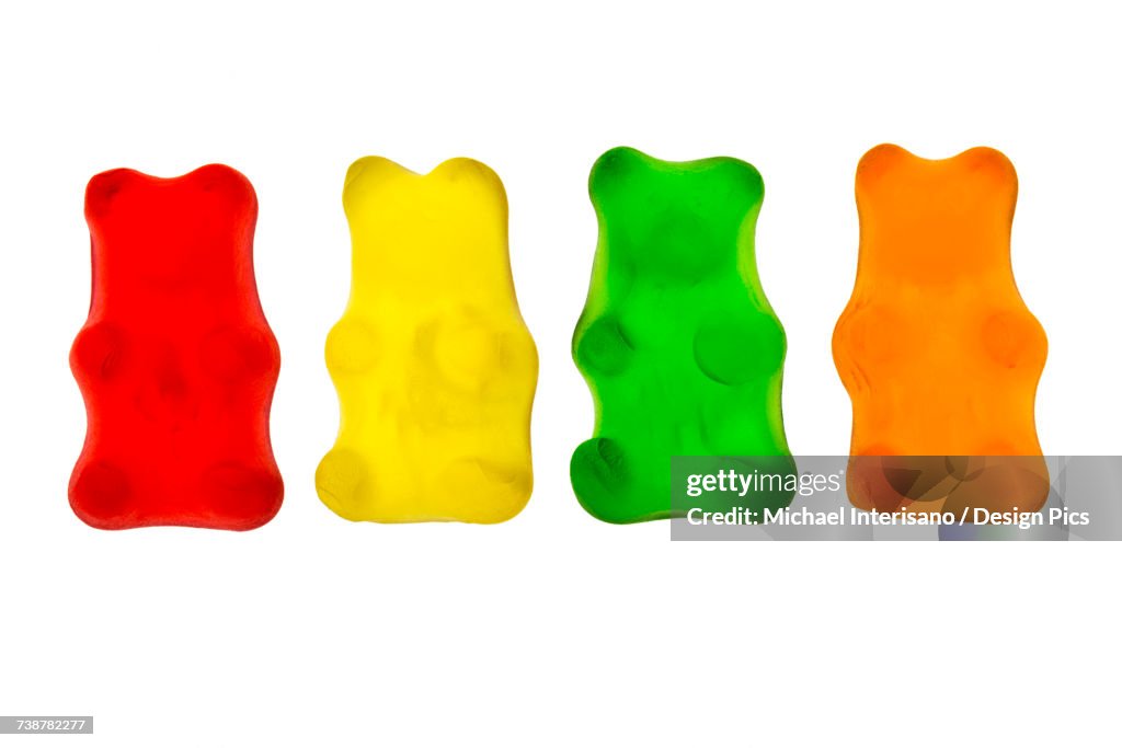 Colourful candied gummy bears in a row backlit