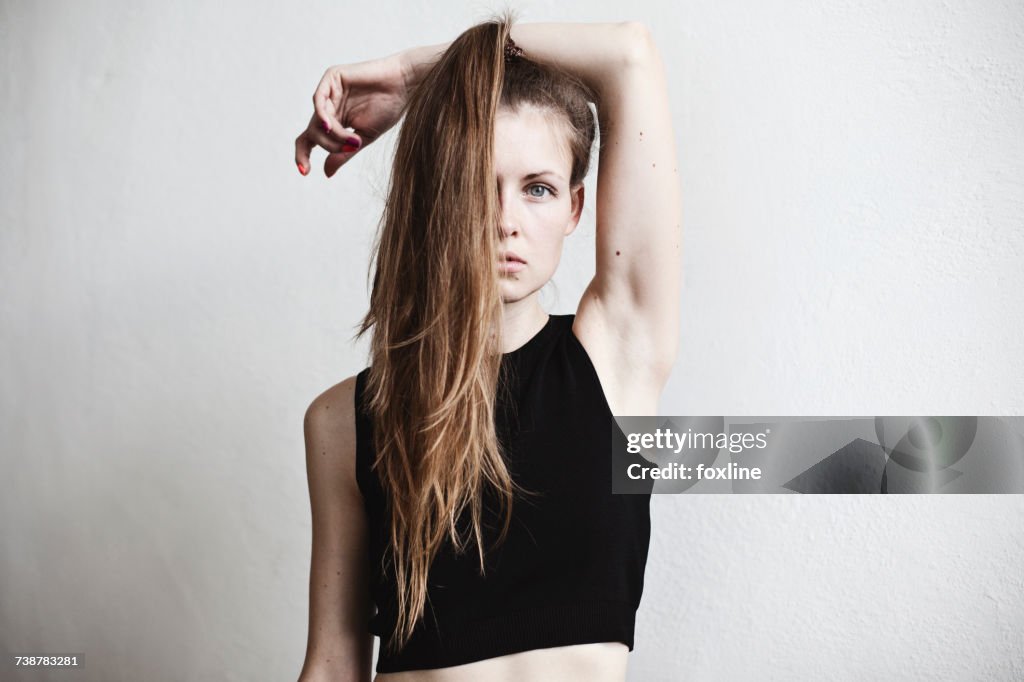 Portrait of a woman with long hair covering her face