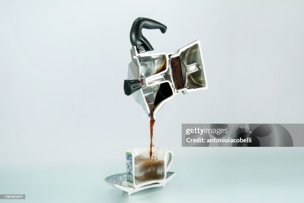 Cross section of an espresso coffee maker, coffee and a cup