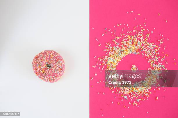Donut covered in sprinkles and donut shape