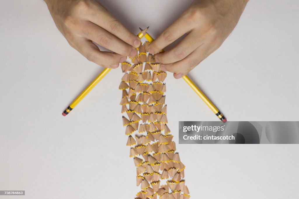 Conceptual hands knitting a scarf