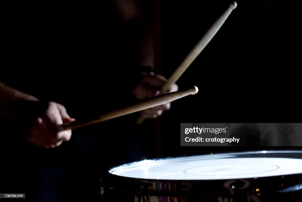 Percussionist playing drums in a recording studio