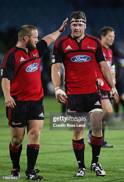 Reuben Thorne of the Crusaders is congratulated by team mate Campbell Johnstone as they leave the field following thei victory in the round 11 Super...