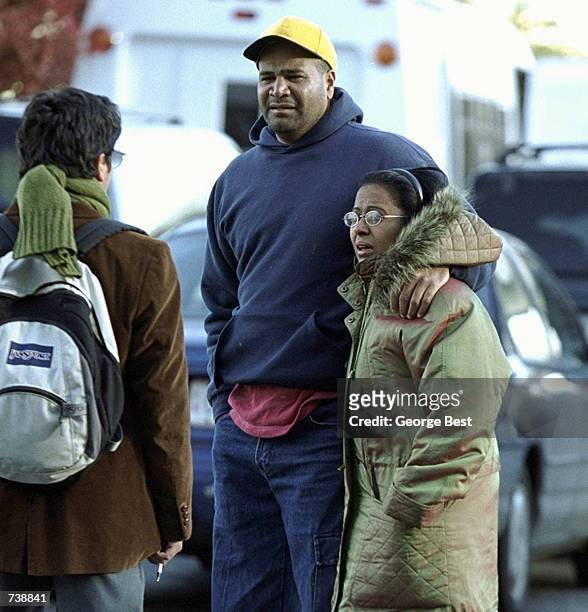 An unidentified man comforts Marina DeLaCruz as she arrives at the Ramada Inn in Queens, New York shortly after learning that her mother and sister...