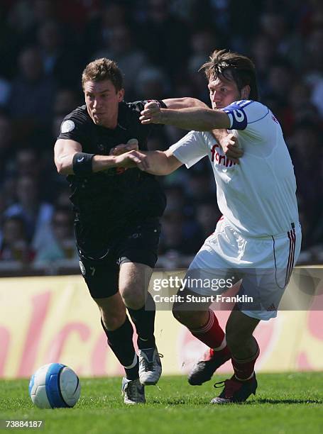 Marvin Braun of St. Pauli is challenged by Sven Boy of Kiel during the Third League match between FC St.Pauli and Holstein Kiel at the Millerntor...