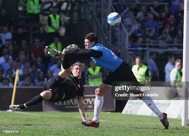 Marvin Braun of St. Pauli shoots past Adrian Horn of Kiel during the Third League match between FC St.Pauli and Holstein Kiel at the Millerntor...