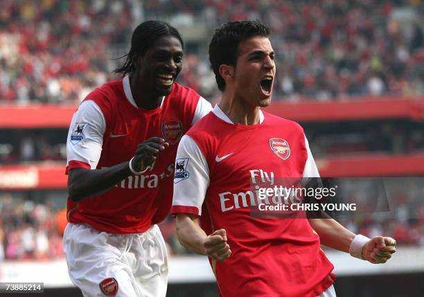 London, UNITED KINGDOM: Arsenal's Spanish midfielder Cesc Fabregas celebrates scoring his side's second goal with Togolese striker Emmanuel Adebayor...