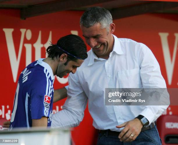 Coach Mirko Slomka shakes hands with his player Lincoln of Schalke after winning 0:3 the Bundesliga match between FSV Mainz 05 and Schalke 04 at the...