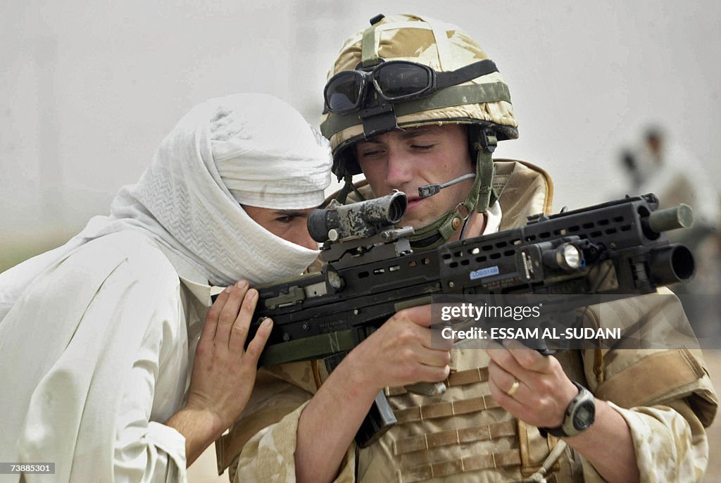 An Iraqi youth looks through the sight o...