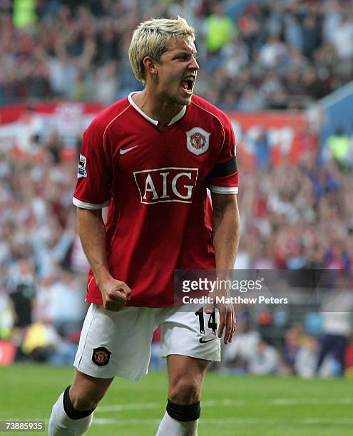 Alan Smith of Manchester United celebrates Wayne Rooney scoring his team's third goal during the FA Cup sponsored by E.ON Semi-final match between...