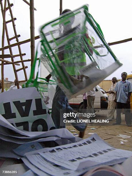 Port Harcourt, NIGERIA: An election official from the Independent National Electoral Commission carries ballot boxes into a collation centre, 14...