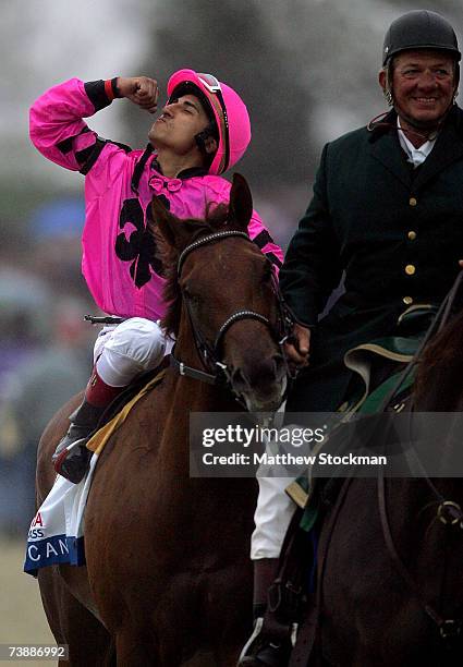 Rafael Bejarno, riding Dominican, celebrates as he is lead to the winner's circle after winning the Toyota Blue Grass Stakes April 14, 2007 at...