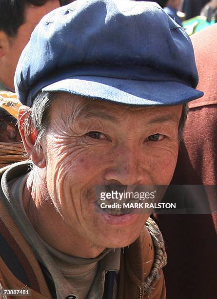 By Benjamin Morgan A Chinese farmer shows his decayed teeth, caused by fluorosis poisoning at his village in Zhijin, Guizhou Province, 15 February...