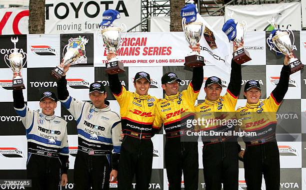 Romain Dumas and Timo Bernhard drivers of the winning Penske Racing Porsche RS Spyder celebrate with second placed Ryan Briscoe and Sacha Maassen and...