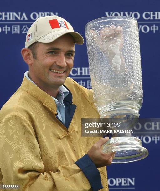 Markus Brier of Austria holds the Volvo China Open winner's trophy at the Silport Golf Club in Shanghai, 15 April 2007. Brier finished 10 under par...