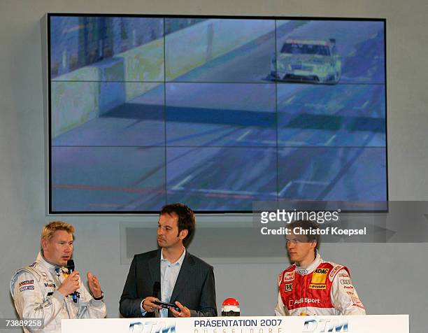 Mika Hakkinen of AMG Mercedes talks to moderator Claus Lufen and Mattias Eksstrom of Audi Sport Team Abt Sportsline during the German Touring Car...