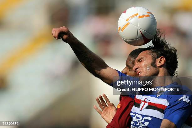 Roma's midfielder Ricardo Faty heads the ball with Sampdoria's forwards Fabio Bazzani during their Italian serie A football match at Rome's Olympic...