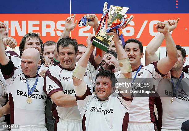 Captain Martin Corry of Leicester holds the Trophy aloft while his team celebrate after winning the EDF Energy Cup Final match between Leicester...