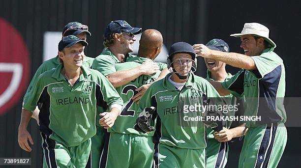 Ireland's Wicket keeper Niall O'Brien and Captain Trent Johnston celebrates the wicket of Bangladesh's Aftab Ahmed with team-mates, during the...