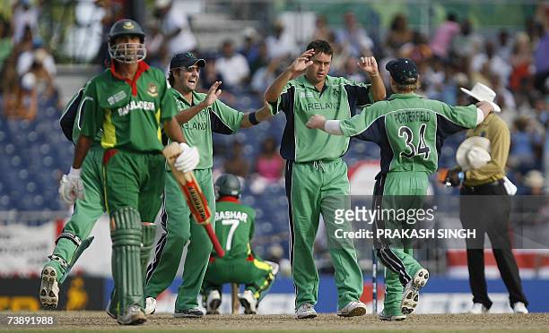 Ireland's Dave Langford-Smith celebrates the wicket of Bangladesh's Mashrafee Murtaza with Kyle McCallan and William Porterfield , during the...