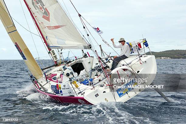 Marie-Galante, FRANCE : French skipper Thomas Rouxel on his "Defi Mousquetaire" monohull, gives the thumb up upon his arrival at the second place of...