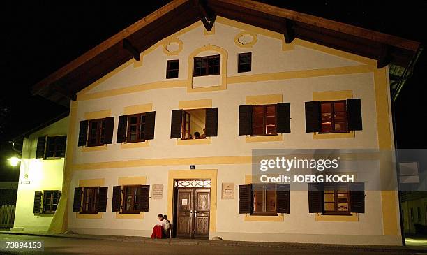 Marktl am Inn, GERMANY: An altar server sits in front of the house in which Pope Benedict XVI, former Cardinal Joseph Ratzinger, was born 16 April...