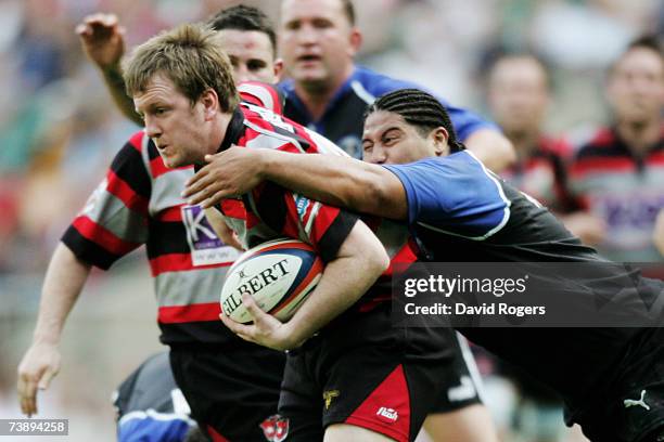 Colum Boland of Dunstablians is tackled by Shane Lolata of Mounts Bay during the EDF Energy Intermediate Cup Final match between Dunstablians and...