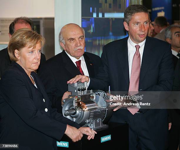 German Chancellor Angela Merkel and Klaus Kleinfeld , CEO of Siemens AG, stand near an engine during the Hanover fair on April 16, 2007 in Hanover,...
