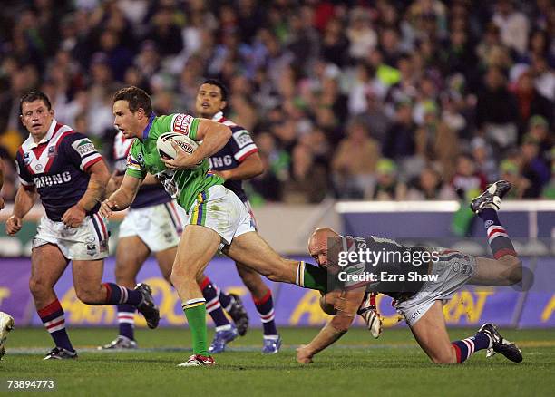 Colin Best of the Raiders is held by Craig Fitzgibbon of the Roosters during the round five NRL match between the Canberra Raiders and the Sydney...