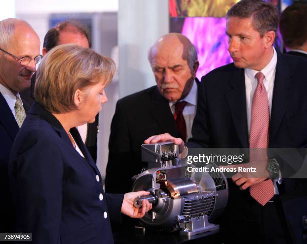 German Chancellor Angela Merkel and Klaus Kleinfeld , CEO of Siemens AG, stand near a engine during the Hanover fair on April 16, 2007 in Hanover,...