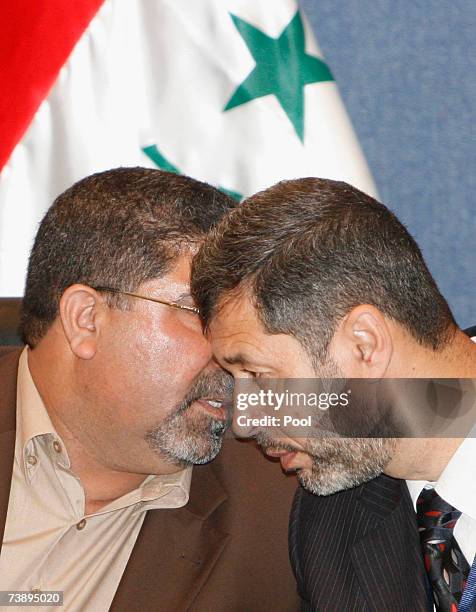 Spokesman of Al-Sadr parliamentary bloc Nassar Al-Rubai speakis with unidentified member of Al-Sadr bloc during press conference April 16, 2007 in...