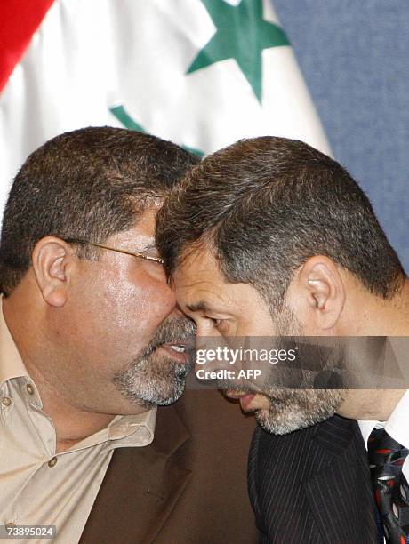 Head of al-Sadr parliamentary bloc Nassar Al-Rubaie speaks with an unidentified member of Al-Sadr bloc during a press conference in Baghdad, 16 April...