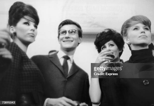 French fashion designer Yves Saint Laurent and his models celebrate the unveiling of his second spring collection at the House of Dior, 28th January...