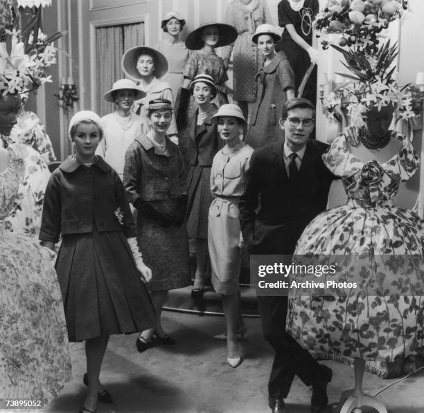 French fashion designer Yves Saint Laurent with a group of models, circa 1960.